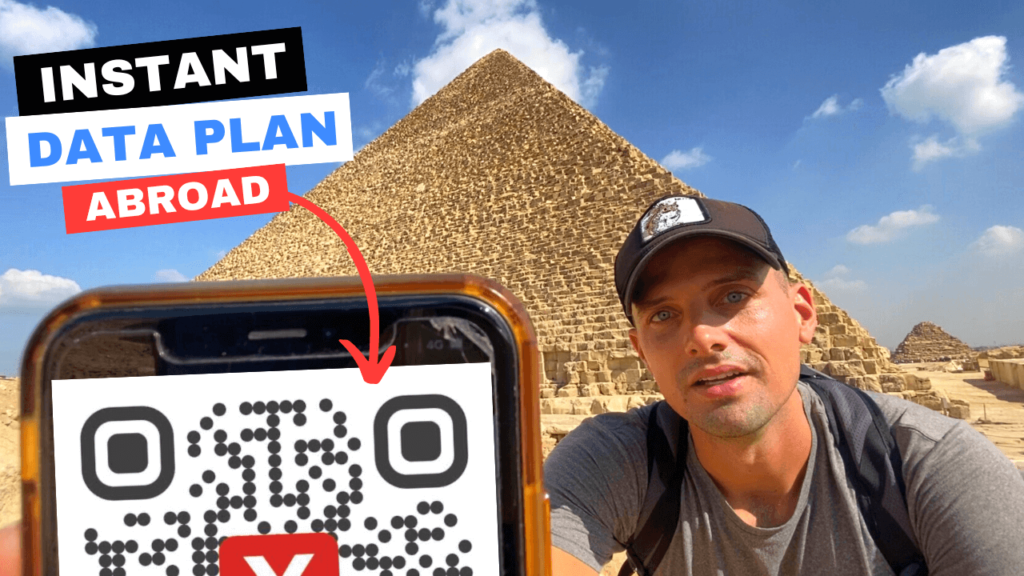 man testing flexiroam esim in front of pyramids of egypt